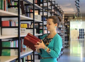 girl with books and shelves