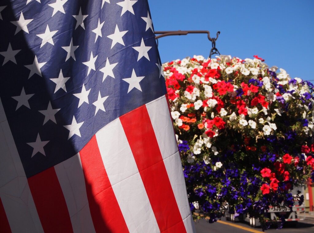U.S. flag with pot of flowers
